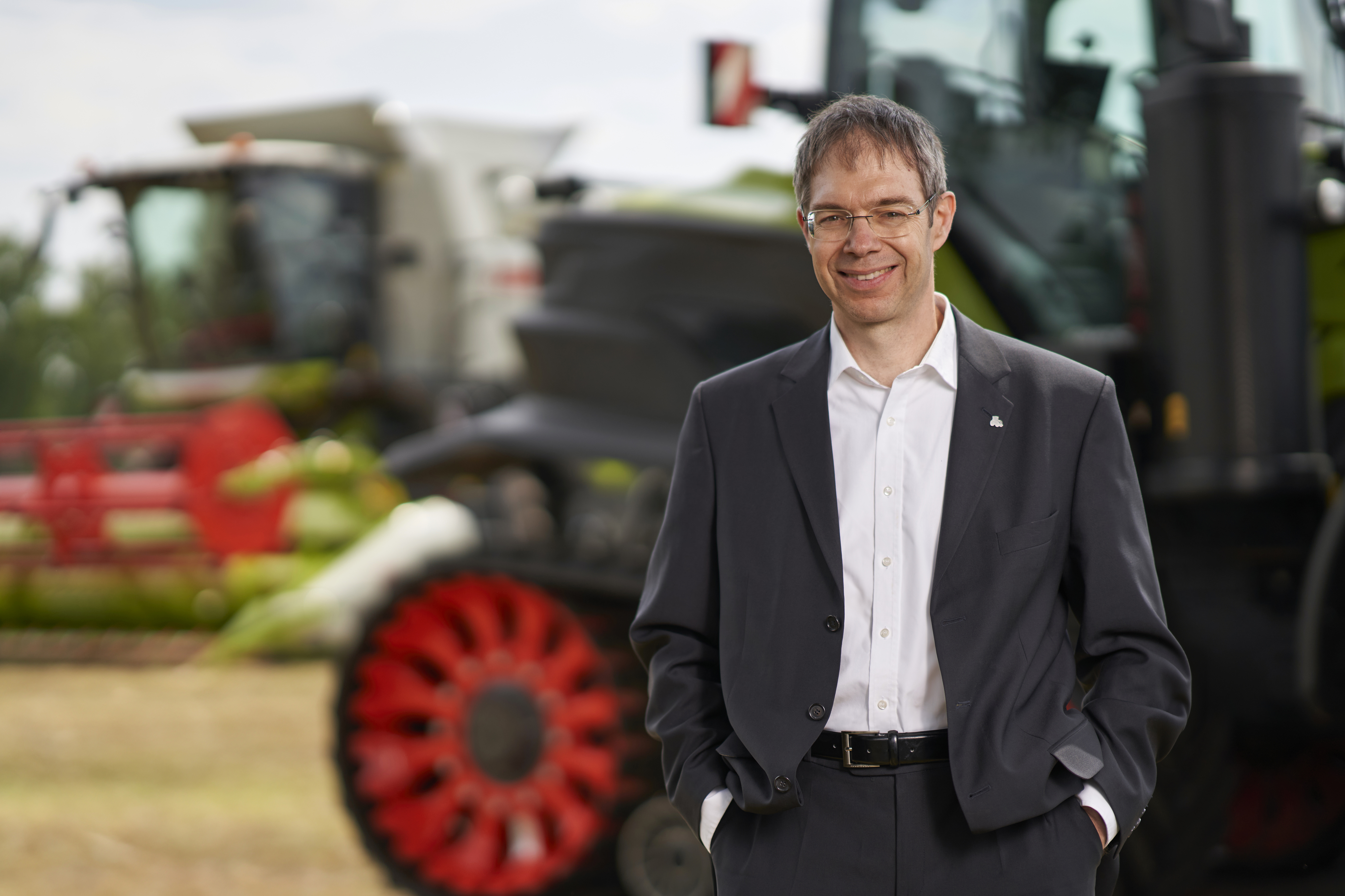 Portrait ofHoyningen-Huene in front of various tractors.
