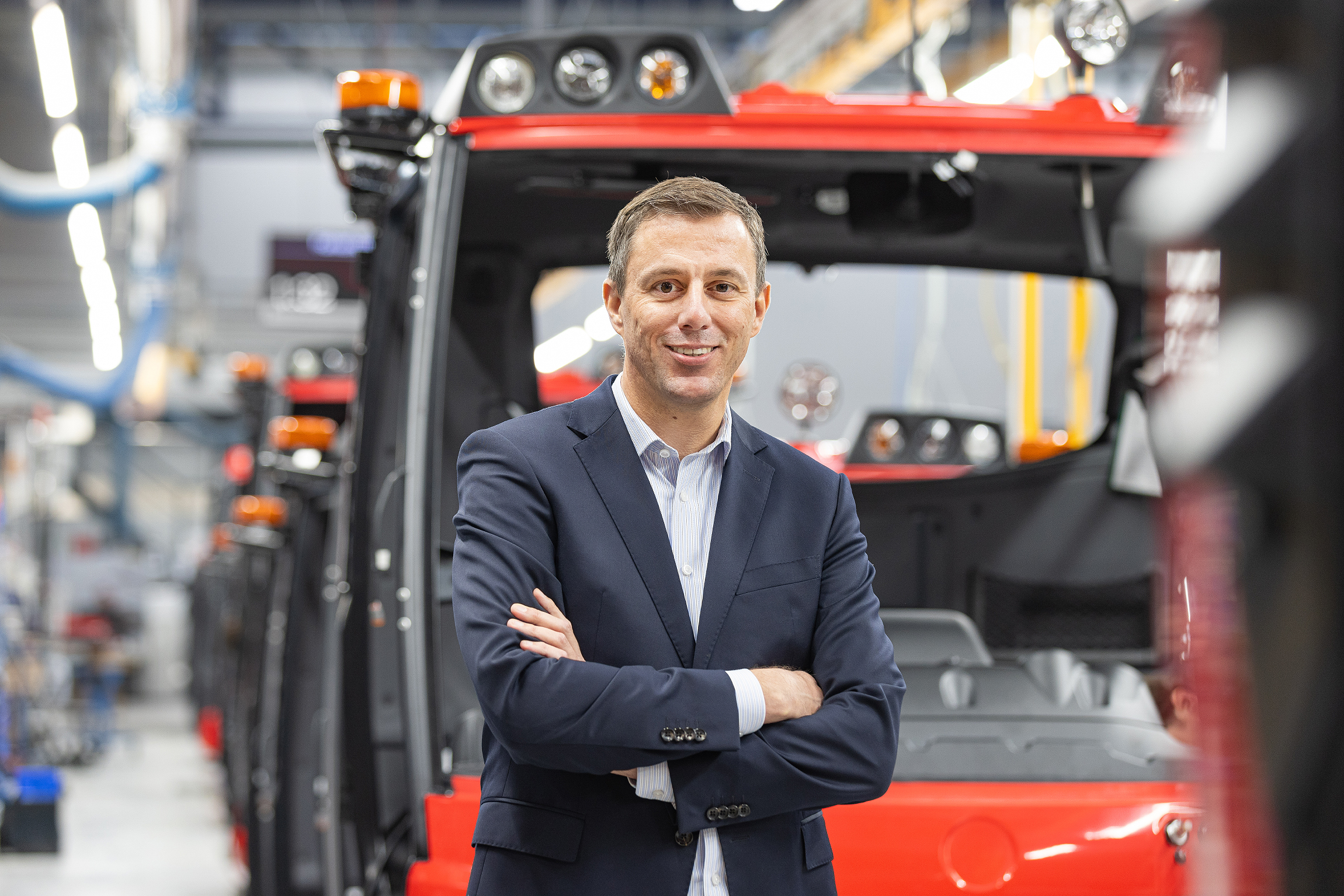 Christian Oberwinkler standing infront of a Truck and smiling into the camera