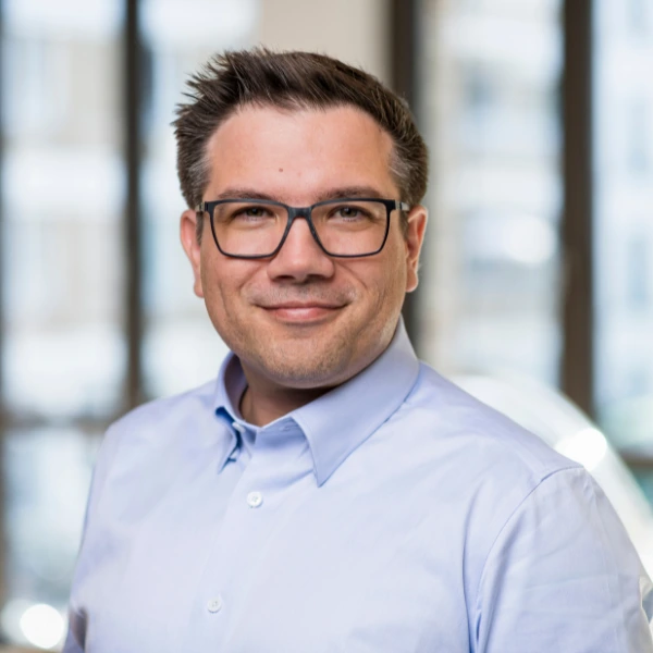 Andreas Nauerz standing and smiling into the camera